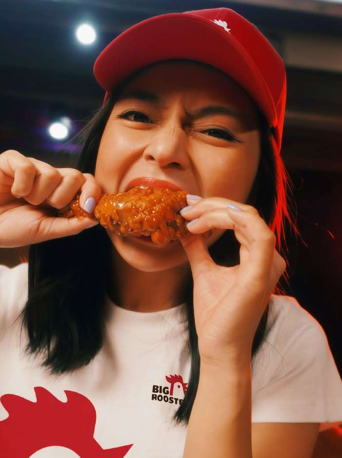 Woman enjoying Big Rooster wing