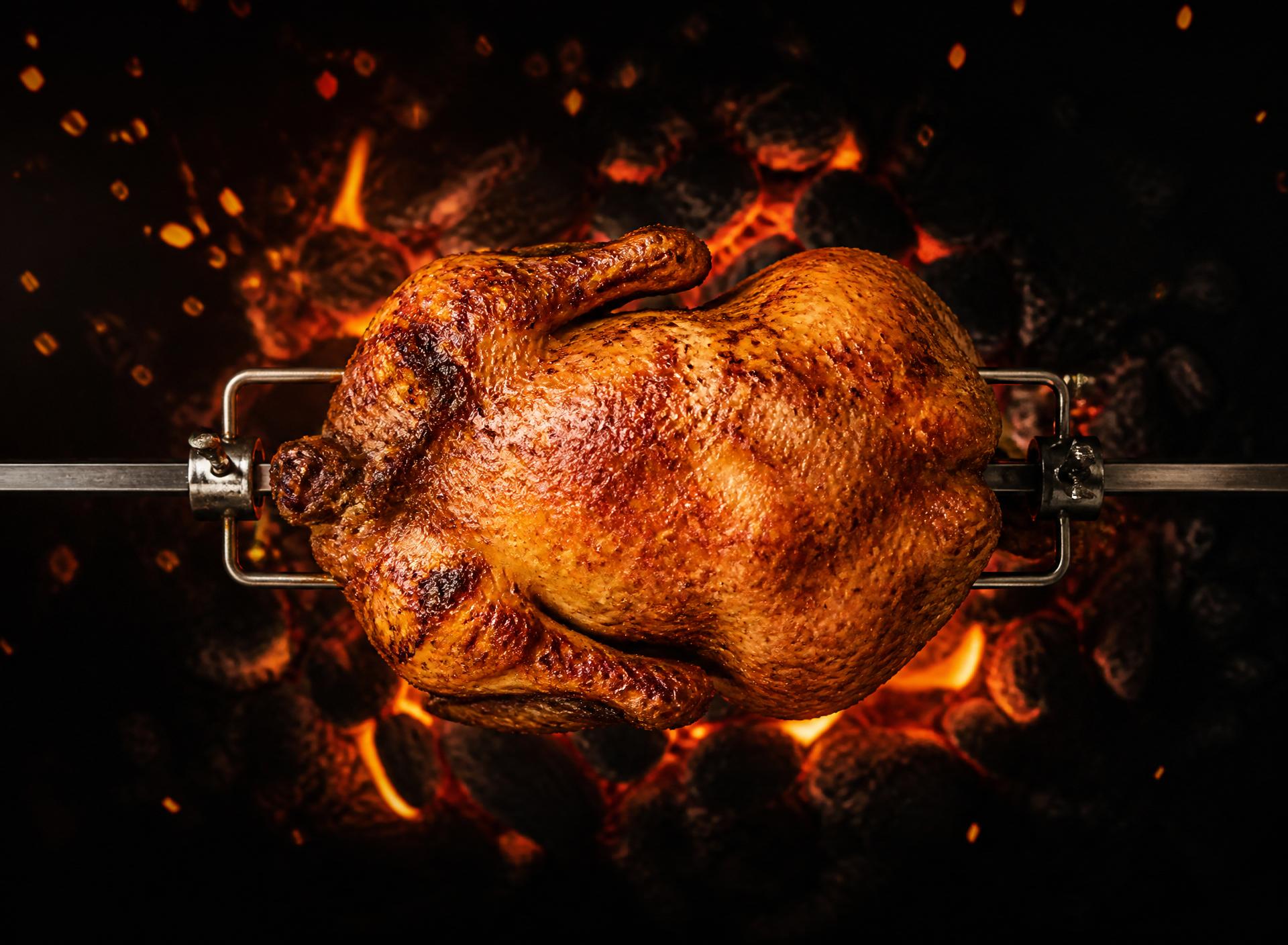 Whole chicken over open flames